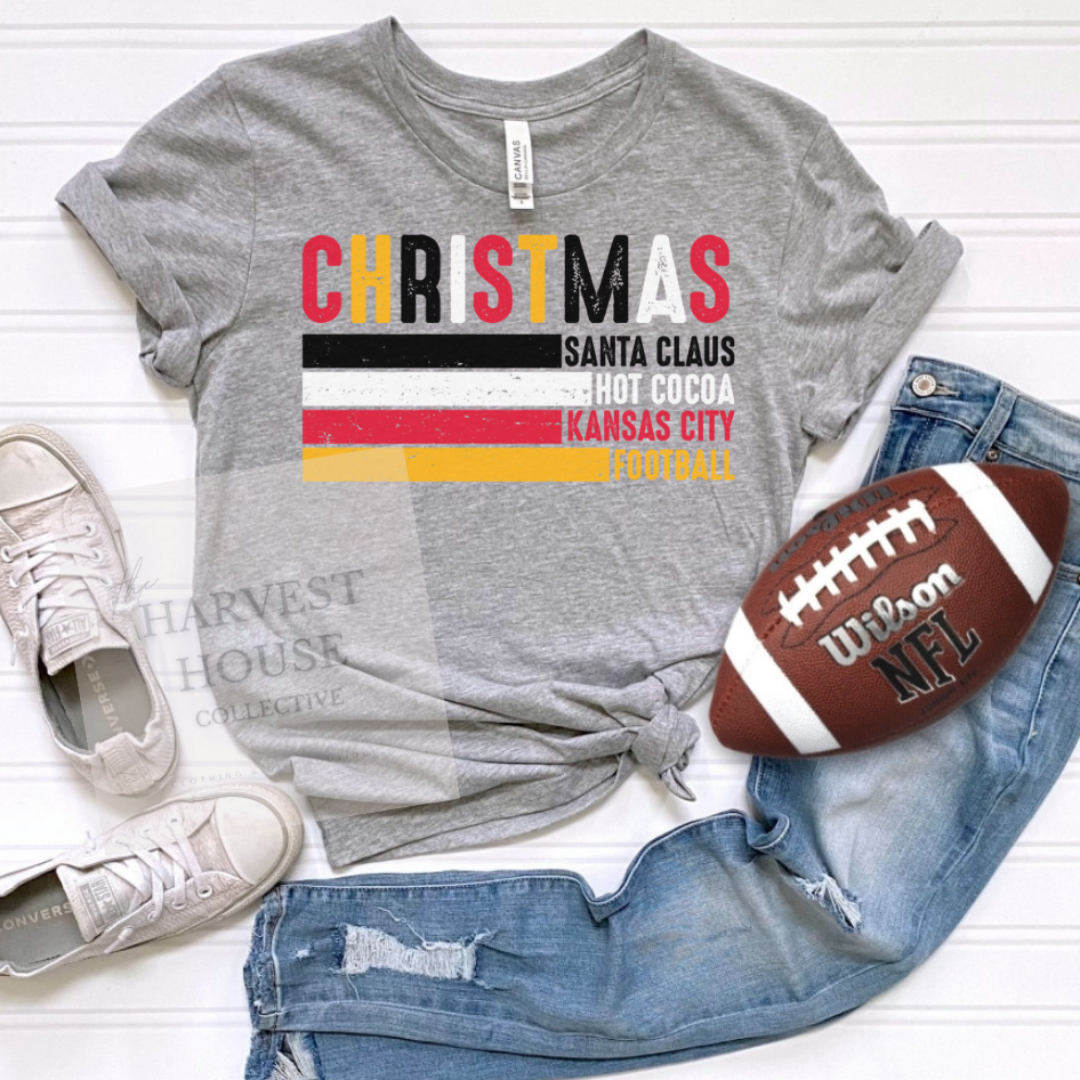 Gray t-shirt with Christmas-themed text, jeans, sneakers, and a football on a white background