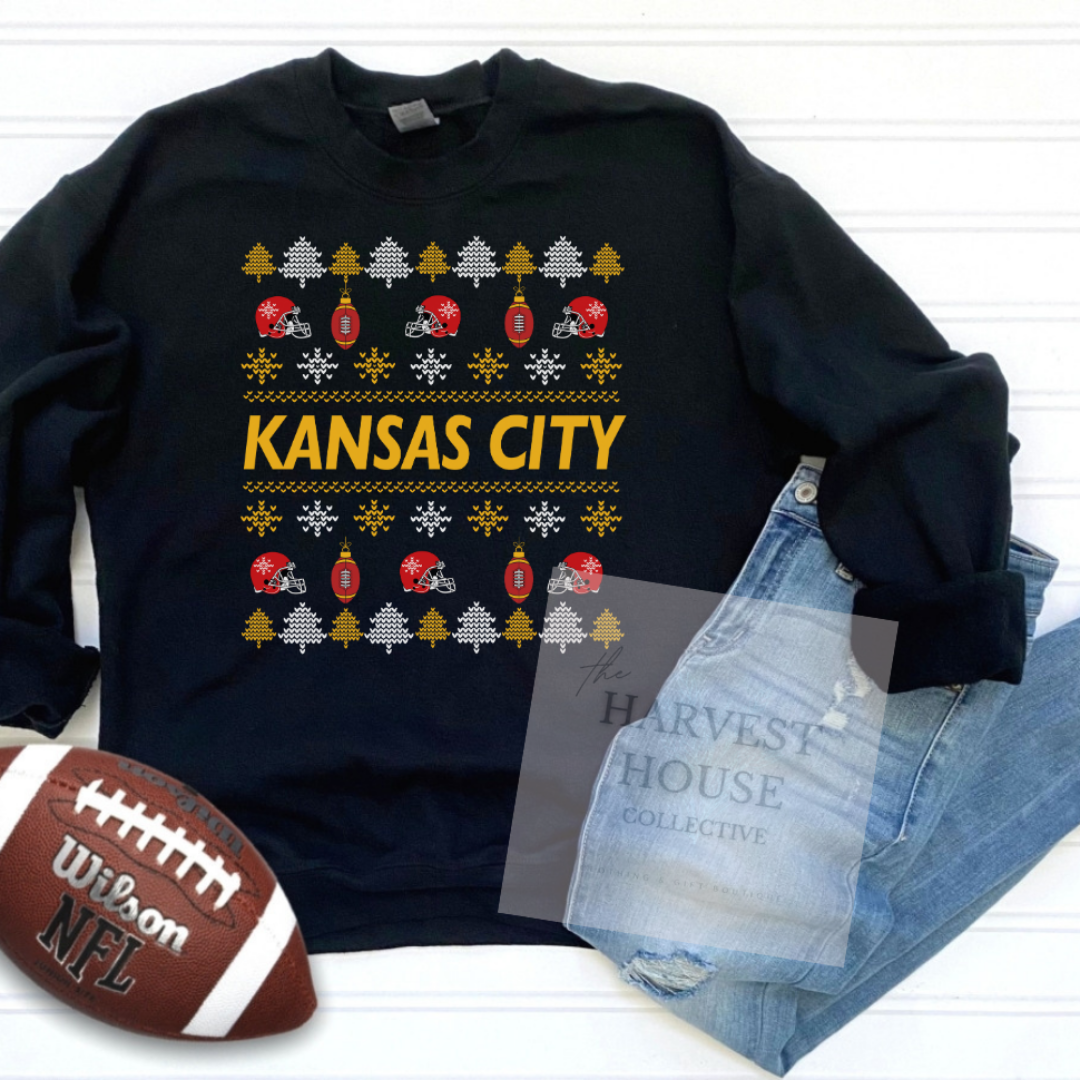Black sweatshirt with 'Kansas City' design, football, and jeans on a white background