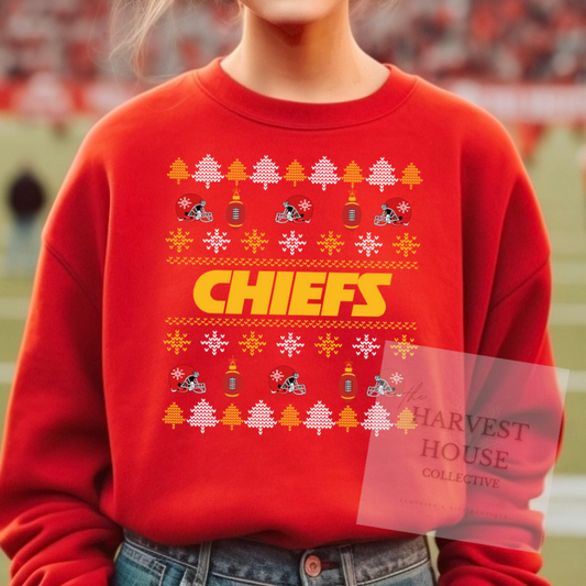 Red sweatshirt with 'CHIEFS' design on a blurred sports field background