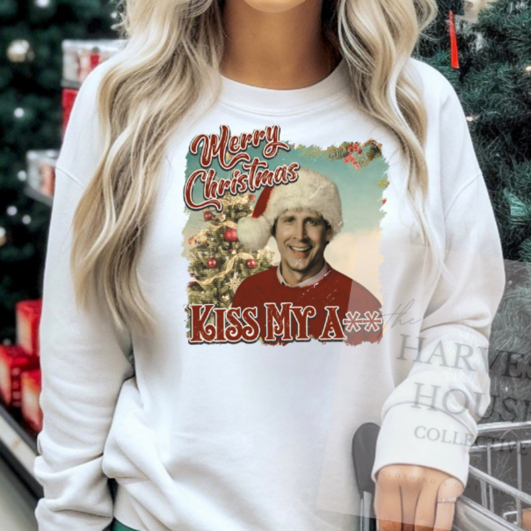 Woman wearing a Christmas-themed sweatshirt in a store with holiday decorations.